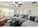 Cozy living room featuring a comfortable sectional sofa, ceiling fan and natural light at 6561 Squire Pl, Douglasville, GA 30135