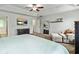 This is a large main bedroom with a ceiling fan, tv, and sitting area at 6561 Squire Pl, Douglasville, GA 30135