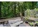 Relaxing back deck featuring potted plants, a small table, and plush outdoor seating with cushions at 3030 Winchester Dr, Cumming, GA 30041
