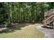 Large backyard area featuring grass and stairs leading to a deck at 3030 Winchester Dr, Cumming, GA 30041