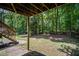 Spacious backyard with lush, mature trees and staircase leading up to a deck at 3030 Winchester Dr, Cumming, GA 30041