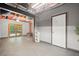 Basement area with exposed wood ceiling, gray walls, double doors and an exterior entrance at 3030 Winchester Dr, Cumming, GA 30041