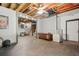 Basement showcasing exposed ceiling, stained concrete floors, a bar area, and additional living space at 3030 Winchester Dr, Cumming, GA 30041