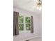 A bedroom with neutral walls and carpet, featuring a window and curtains, creating a serene space at 3030 Winchester Dr, Cumming, GA 30041