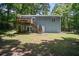 View of the exterior featuring a deck and staircase with a spacious backyard at 3030 Winchester Dr, Cumming, GA 30041