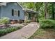 Close up on the landscaped yard with a home featuring gray siding and a charming front porch at 3030 Winchester Dr, Cumming, GA 30041