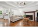 Bright living room featuring a cozy fireplace, hardwood floors, and an open layout at 3030 Winchester Dr, Cumming, GA 30041