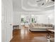 Bright living room with wood floors, neutral paint, and an open doorway into the kitchen at 3030 Winchester Dr, Cumming, GA 30041