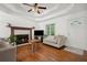 Living room features a ceiling fan, wood floors, a fireplace, and plenty of natural light at 3030 Winchester Dr, Cumming, GA 30041