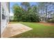 Spacious backyard features a concrete patio and lush green lawn, perfect for outdoor enjoyment at 5156 Amberden Hall Dr, Suwanee, GA 30024
