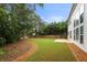 Well-maintained backyard with mulch, grass, and patio provides a peaceful retreat at 5156 Amberden Hall Dr, Suwanee, GA 30024