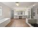 Bright bathroom with double vanity, soaking tub and walk-in shower with glass enclosure at 5156 Amberden Hall Dr, Suwanee, GA 30024