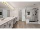 Bright bathroom with double vanity and walk-in shower with glass enclosure at 5156 Amberden Hall Dr, Suwanee, GA 30024