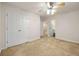 Neutral bedroom with carpet, closet, and ceiling fan provides a relaxing atmosphere at 5156 Amberden Hall Dr, Suwanee, GA 30024