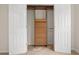Walk-in closet featuring custom wooden shelving and storage unit at 5156 Amberden Hall Dr, Suwanee, GA 30024