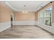Bright dining room featuring wood floors, decorative trim, and large window at 5156 Amberden Hall Dr, Suwanee, GA 30024