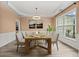 Elegant dining room featuring wood floors, decorative trim, and large window at 5156 Amberden Hall Dr, Suwanee, GA 30024