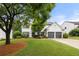 Charming two-story home with a well-manicured lawn and attached two-car garage at 5156 Amberden Hall Dr, Suwanee, GA 30024