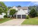 Charming two-story home with a well-manicured lawn and a two-car garage at 5156 Amberden Hall Dr, Suwanee, GA 30024