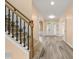 Beautiful foyer with staircase, wood floors, and lots of natural light at 5156 Amberden Hall Dr, Suwanee, GA 30024