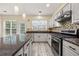 Spacious kitchen featuring granite counters, stainless steel appliances and a beautiful backsplash at 5156 Amberden Hall Dr, Suwanee, GA 30024