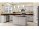 Stylish kitchen with granite counters, stainless appliances, island, and a tile backsplash at 5156 Amberden Hall Dr, Suwanee, GA 30024