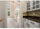 A beautiful living space featuring gorgeous wood-look flooring and a partial kitchen view at 5156 Amberden Hall Dr, Suwanee, GA 30024