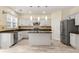 Modern kitchen with granite countertops, stainless appliances, tile backsplash, and center island at 5156 Amberden Hall Dr, Suwanee, GA 30024