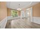 Open-concept living room with wood floors and large window with natural light at 5156 Amberden Hall Dr, Suwanee, GA 30024