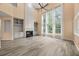 Bright living room features a fireplace, large windows, and custom built-ins at 5156 Amberden Hall Dr, Suwanee, GA 30024