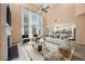 Bright living room with soaring ceilings, fireplace, and open layout to kitchen at 5156 Amberden Hall Dr, Suwanee, GA 30024