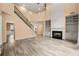Bright living room featuring a fireplace, staircase, and custom built-ins at 5156 Amberden Hall Dr, Suwanee, GA 30024
