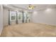 Spacious primary bedroom with trey ceiling, ceiling fan, and large windows at 5156 Amberden Hall Dr, Suwanee, GA 30024