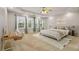 Serene main bedroom featuring a tray ceiling, large windows, and neutral decor at 5156 Amberden Hall Dr, Suwanee, GA 30024
