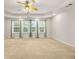 Large main bedroom features a tray ceiling, fan, and three large windows allowing for natural light at 5156 Amberden Hall Dr, Suwanee, GA 30024