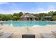 Large community pool with ample seating and shade, ideal for summer relaxation at 5156 Amberden Hall Dr, Suwanee, GA 30024