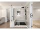 Detailed view of frameless shower with bench, tile surround, and modern fixtures at 5156 Amberden Hall Dr, Suwanee, GA 30024