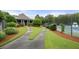Clubhouse entrance next to tennis court, surrounded by lush landscaping, perfect for active lifestyles at 5156 Amberden Hall Dr, Suwanee, GA 30024