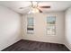 Cozy bedroom with two windows bringing in natural light, ceiling fan and neutral walls at 6092 Giles Ct, Lithonia, GA 30058