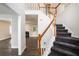 Inviting home entryway featuring a staircase with wood railing and views of the living room at 6092 Giles Ct, Lithonia, GA 30058