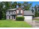 Charming two-story home featuring a mix of brick and siding with a well-maintained lawn at 6092 Giles Ct, Lithonia, GA 30058