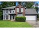 Traditional two-story home with brick and siding, featuring a well-manicured front yard at 6092 Giles Ct, Lithonia, GA 30058