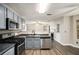 Bright kitchen with stainless steel appliances and a view to the living room with a fireplace at 6092 Giles Ct, Lithonia, GA 30058
