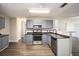 Updated kitchen featuring stainless steel appliances, gray cabinets, and modern countertops at 6092 Giles Ct, Lithonia, GA 30058