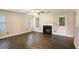 Open living area with a fireplace, modern flooring, and access to the backyard at 6092 Giles Ct, Lithonia, GA 30058