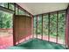 Bright sunroom with screened windows and a door leading to a wood deck, offering views of the greenery at 6092 Giles Ct, Lithonia, GA 30058
