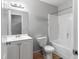 Neat bathroom featuring a sink, toilet, vanity, and a shower-tub combo at 7268 Loblolly Ln, Morrow, GA 30260