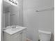 A standard white bathroom with a single sink vanity and a framed mirror at 7268 Loblolly Ln, Morrow, GA 30260