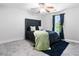 Modern bedroom with a decorative ceiling fan and window views of the outdoors at 7268 Loblolly Ln, Morrow, GA 30260