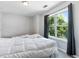 Comfortable bedroom offers ample natural light through the large window with black curtains at 7268 Loblolly Ln, Morrow, GA 30260